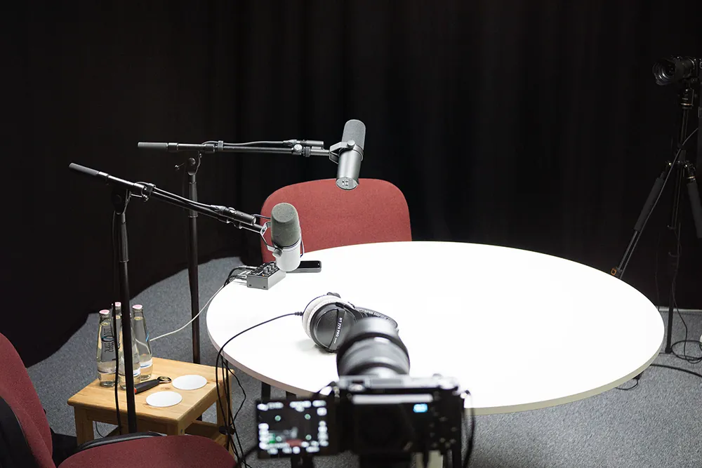 Podcast-Set mit weißem runden Tisch im Fokuston-Studio